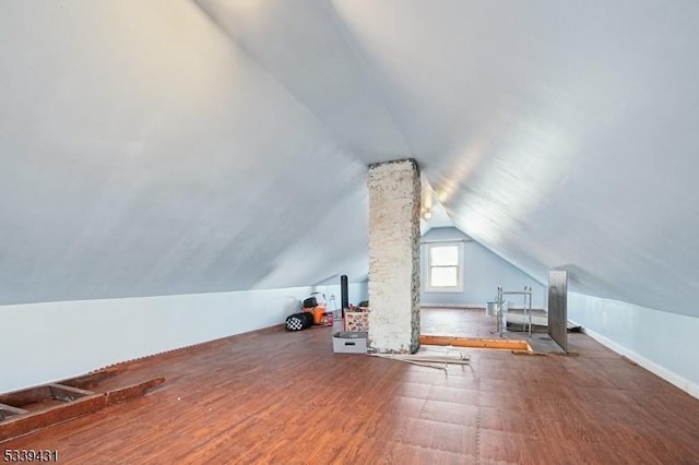 bonus room featuring lofted ceiling and wood finished floors