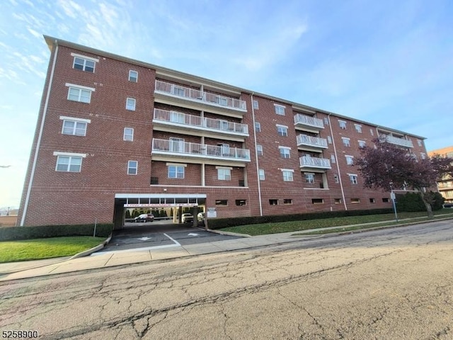 view of building exterior with covered parking