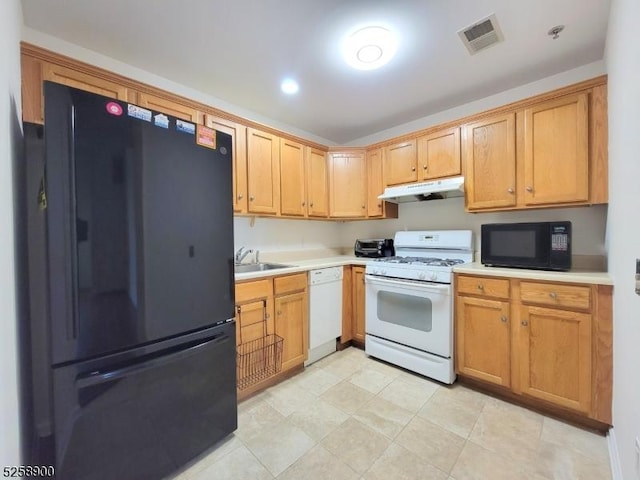 kitchen with black appliances, under cabinet range hood, visible vents, and light countertops