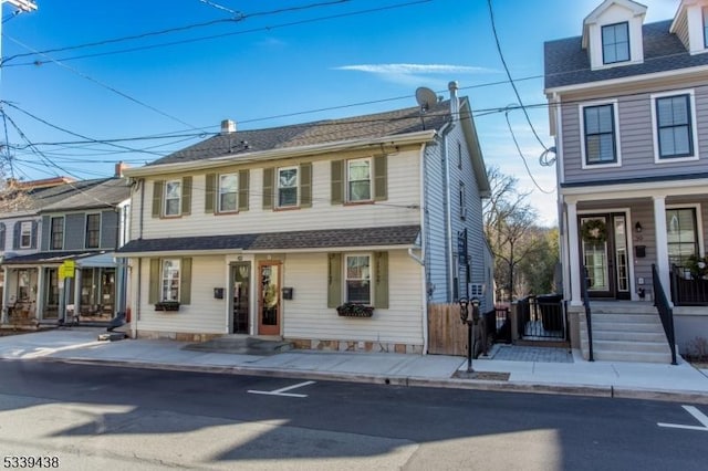 view of front of home with a shingled roof