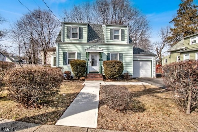 view of front of house featuring roof with shingles, driveway, and an attached garage