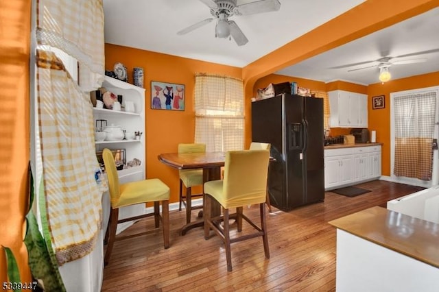 dining area with a healthy amount of sunlight, light wood-style floors, and ceiling fan