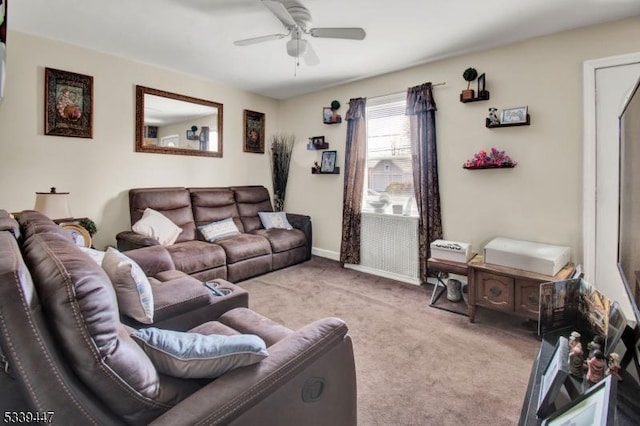 living room with light carpet, a ceiling fan, and baseboards