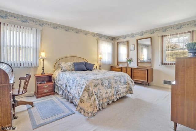 bedroom featuring visible vents, carpet flooring, and baseboards