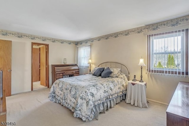 carpeted bedroom with baseboards