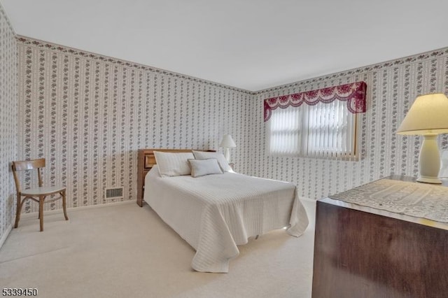 bedroom with light carpet, visible vents, wallpapered walls, and baseboards