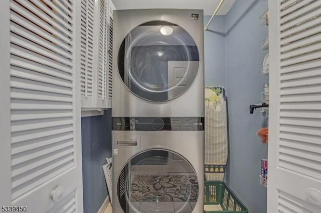 laundry room with laundry area and stacked washer / dryer