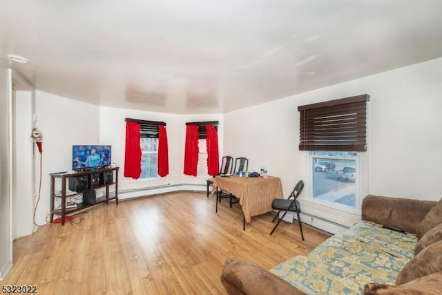 living area with a baseboard radiator and wood finished floors