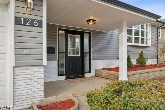 doorway to property featuring covered porch