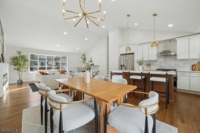 dining space with recessed lighting, high vaulted ceiling, dark wood finished floors, and a glass covered fireplace