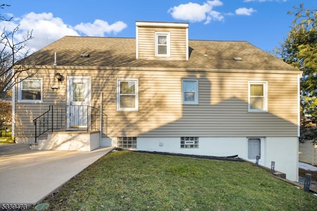 view of front of property with a front yard and roof with shingles