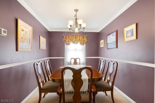 dining area featuring crown molding, a notable chandelier, carpet floors, and baseboards