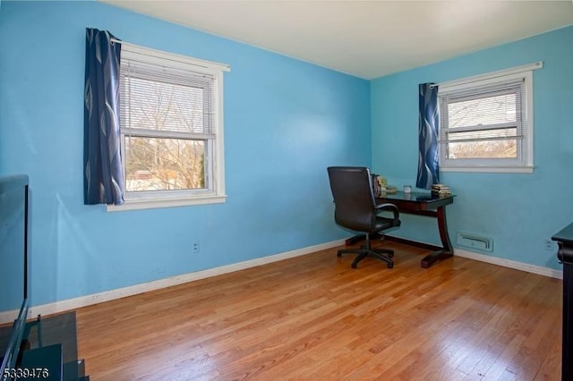 office space featuring baseboards and wood finished floors