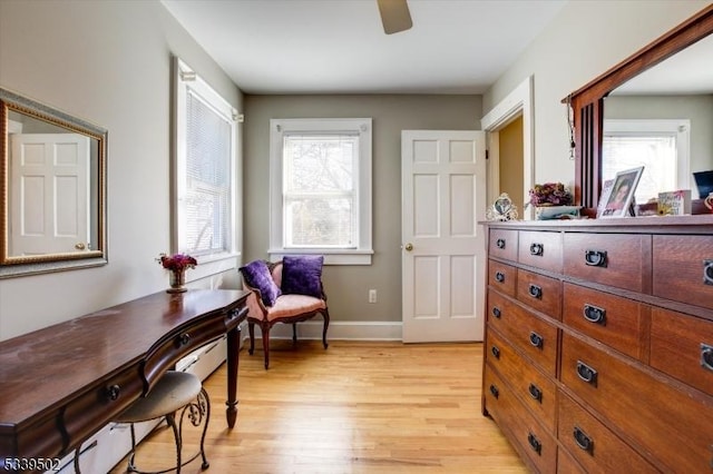 sitting room featuring light wood-style flooring, baseboards, and a ceiling fan