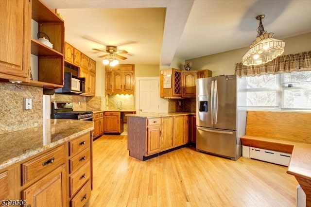 kitchen with a baseboard radiator, appliances with stainless steel finishes, open shelves, brown cabinetry, and pendant lighting