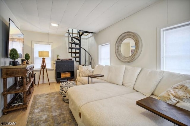 living area with stairs and wood finished floors