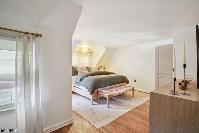 bedroom with baseboards and light wood finished floors