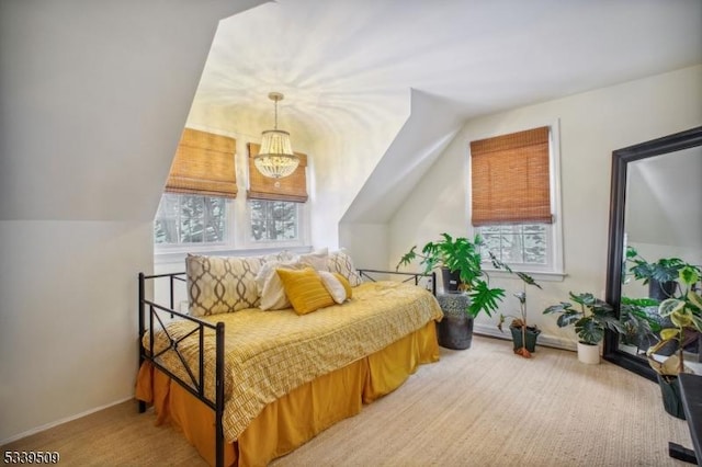 bedroom with light carpet, multiple windows, and vaulted ceiling