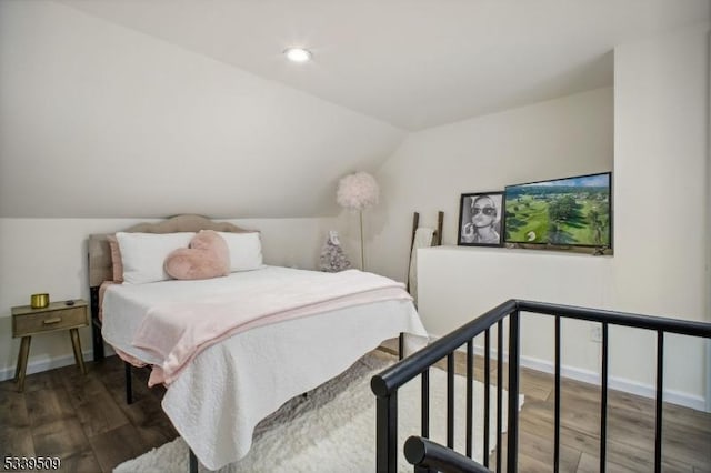 bedroom featuring baseboards, vaulted ceiling, wood finished floors, and recessed lighting