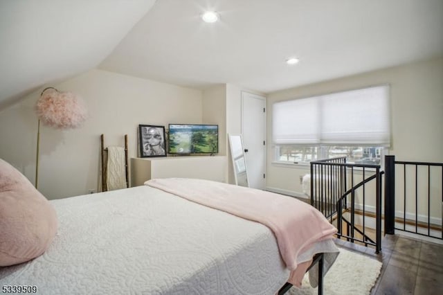 bedroom featuring baseboards, vaulted ceiling, wood finished floors, and recessed lighting