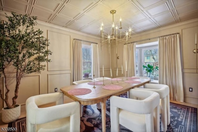 dining room with ornamental molding, a wealth of natural light, an ornate ceiling, and an inviting chandelier