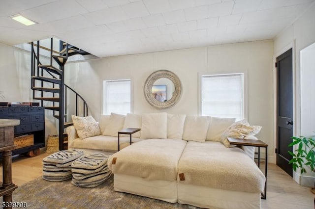 living room featuring wood finished floors and stairs