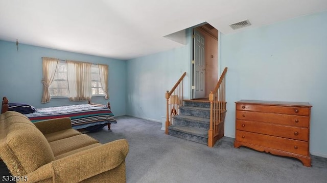 carpeted bedroom featuring visible vents