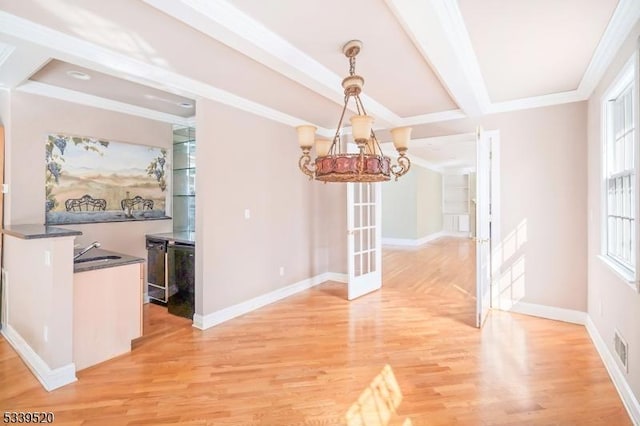 unfurnished dining area with baseboards, wood finished floors, and french doors