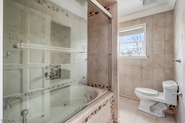 full bath featuring tile patterned flooring, toilet, visible vents, tile walls, and a combined bath / shower with jetted tub