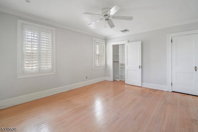 unfurnished bedroom featuring light wood-style floors, ornamental molding, and baseboards