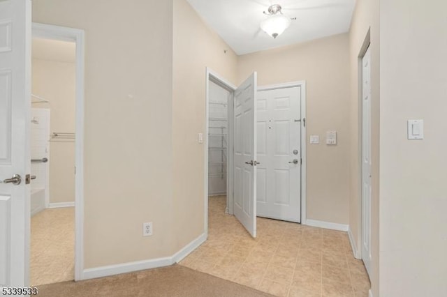 interior space featuring baseboards and a closet