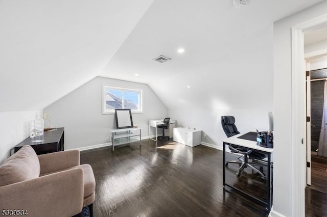 office area featuring dark wood-style floors, visible vents, vaulted ceiling, and baseboards