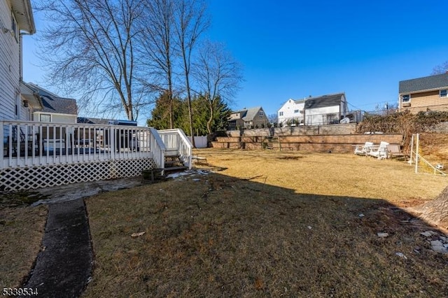 view of yard featuring a wooden deck and fence