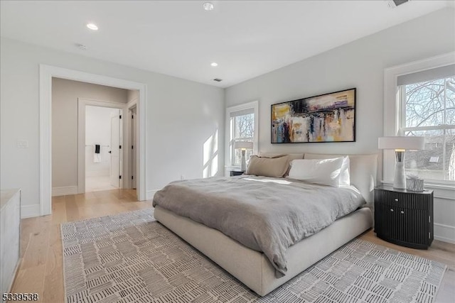 bedroom featuring light wood-type flooring, baseboards, and recessed lighting