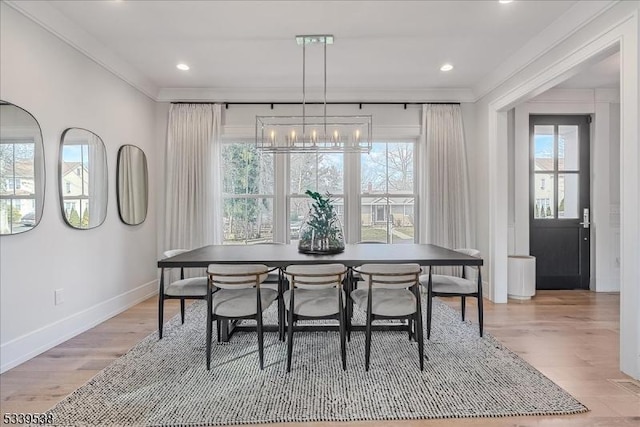 dining area featuring a chandelier, light wood-style flooring, recessed lighting, baseboards, and ornamental molding