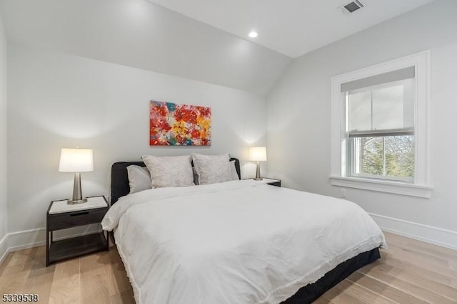 bedroom featuring lofted ceiling, light wood-style flooring, recessed lighting, visible vents, and baseboards