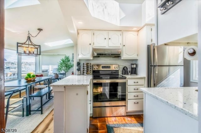 kitchen with under cabinet range hood, white cabinetry, stainless steel appliances, and pendant lighting