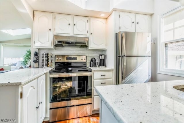 kitchen featuring under cabinet range hood, white cabinetry, stainless steel appliances, and light stone counters