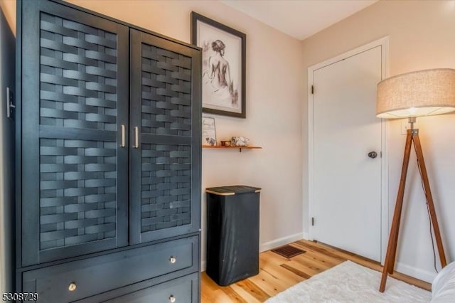 interior space featuring light wood finished floors and baseboards