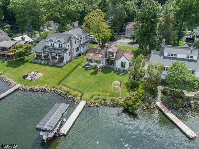 drone / aerial view featuring a water view and a residential view