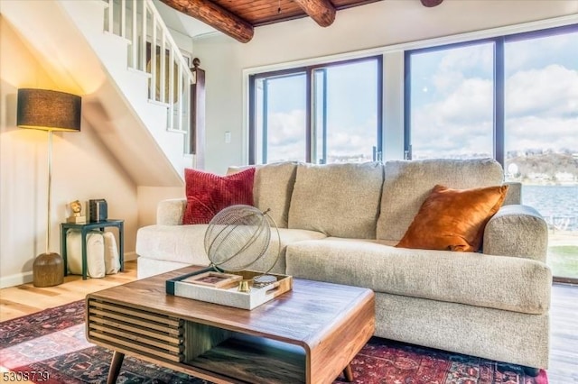 living room with stairs, beam ceiling, wooden ceiling, and wood finished floors