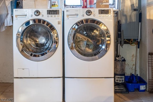 washroom featuring laundry area, washer and clothes dryer, and tile patterned floors