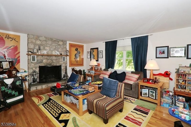 living area featuring a fireplace and wood finished floors