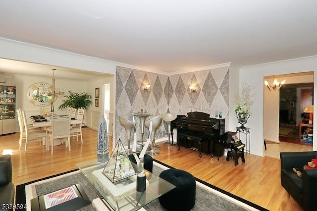 living room featuring crown molding, wood finished floors, and a chandelier