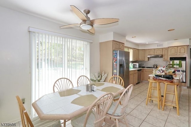 dining room with a ceiling fan, light tile patterned flooring, and visible vents