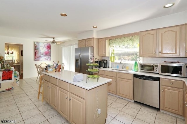 kitchen featuring a sink, light brown cabinets, and stainless steel appliances
