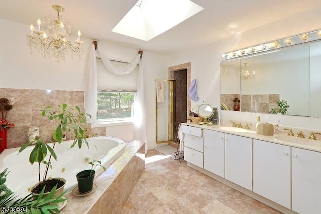 full bathroom featuring an inviting chandelier, double vanity, a sink, and a tub with jets