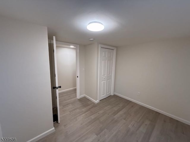 interior space featuring baseboards and wood finished floors