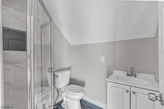 bathroom featuring toilet, a shower stall, vaulted ceiling, and vanity