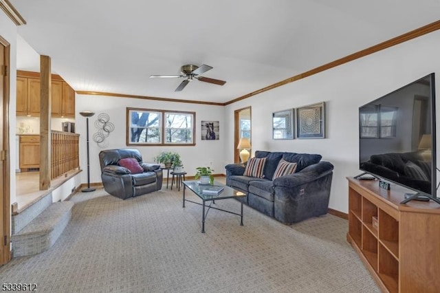 living area featuring a ceiling fan, light carpet, crown molding, and baseboards